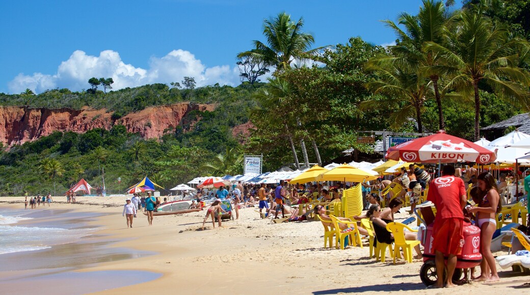 Pitinga Beach which includes a sandy beach, general coastal views and outdoor eating