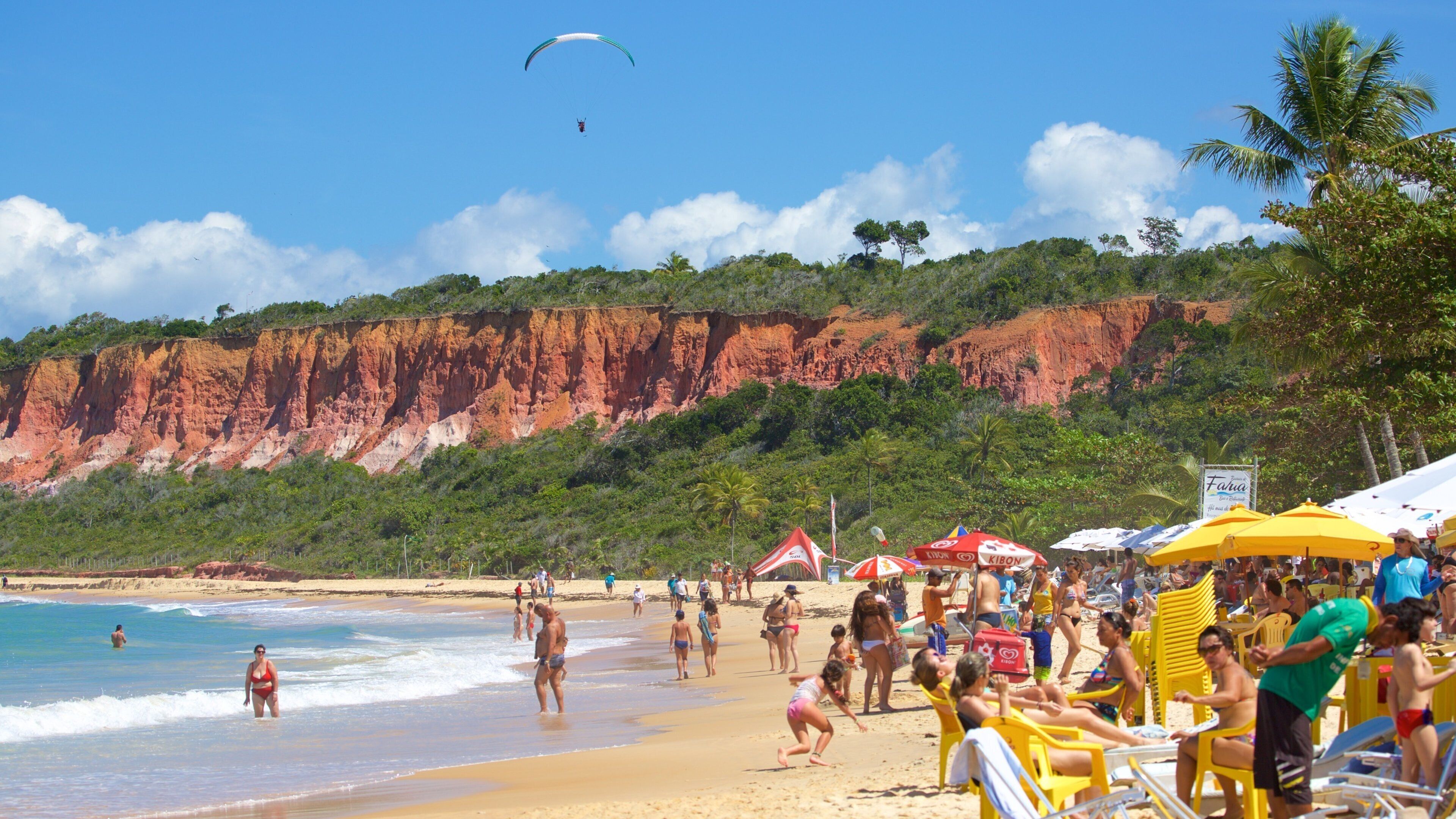 Pitinga Beach featuring a beach and general coastal views as well as a large group of people