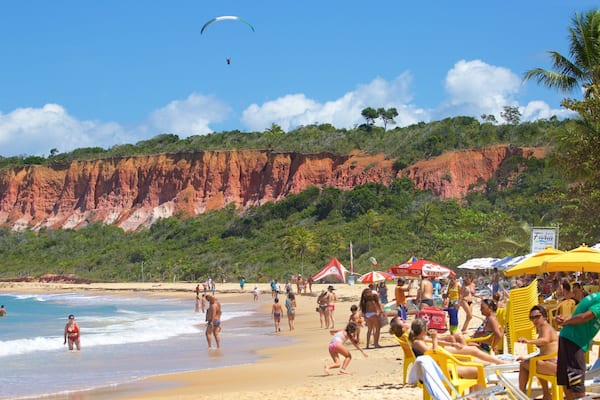 Pitinga Beach featuring a beach and general coastal views as well as a large group of people