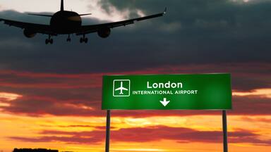 Plane landing in London England, UK airport with signboard