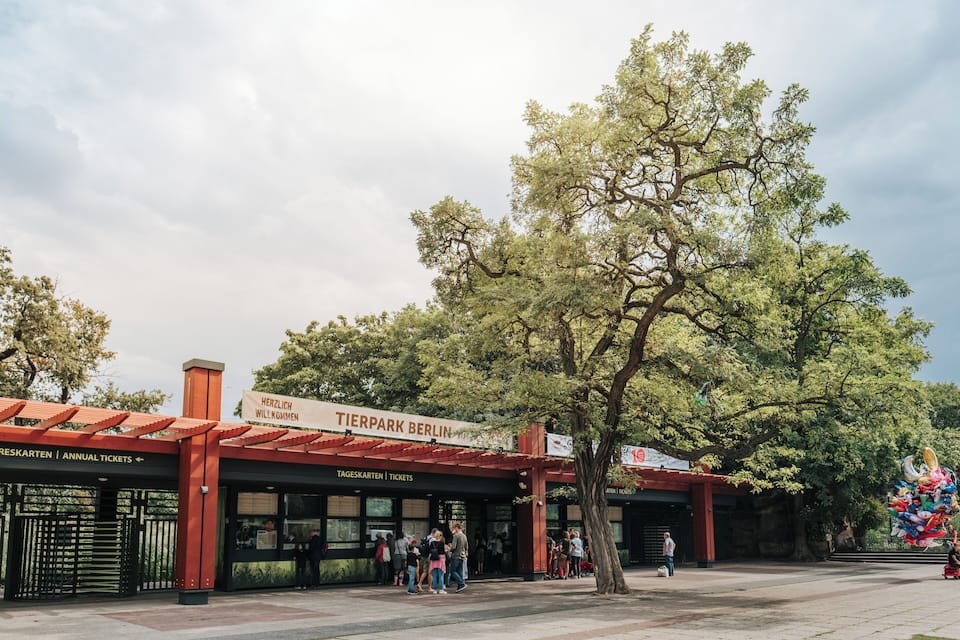 Tierpark Berlin entrance with ticket booths and people waiting.