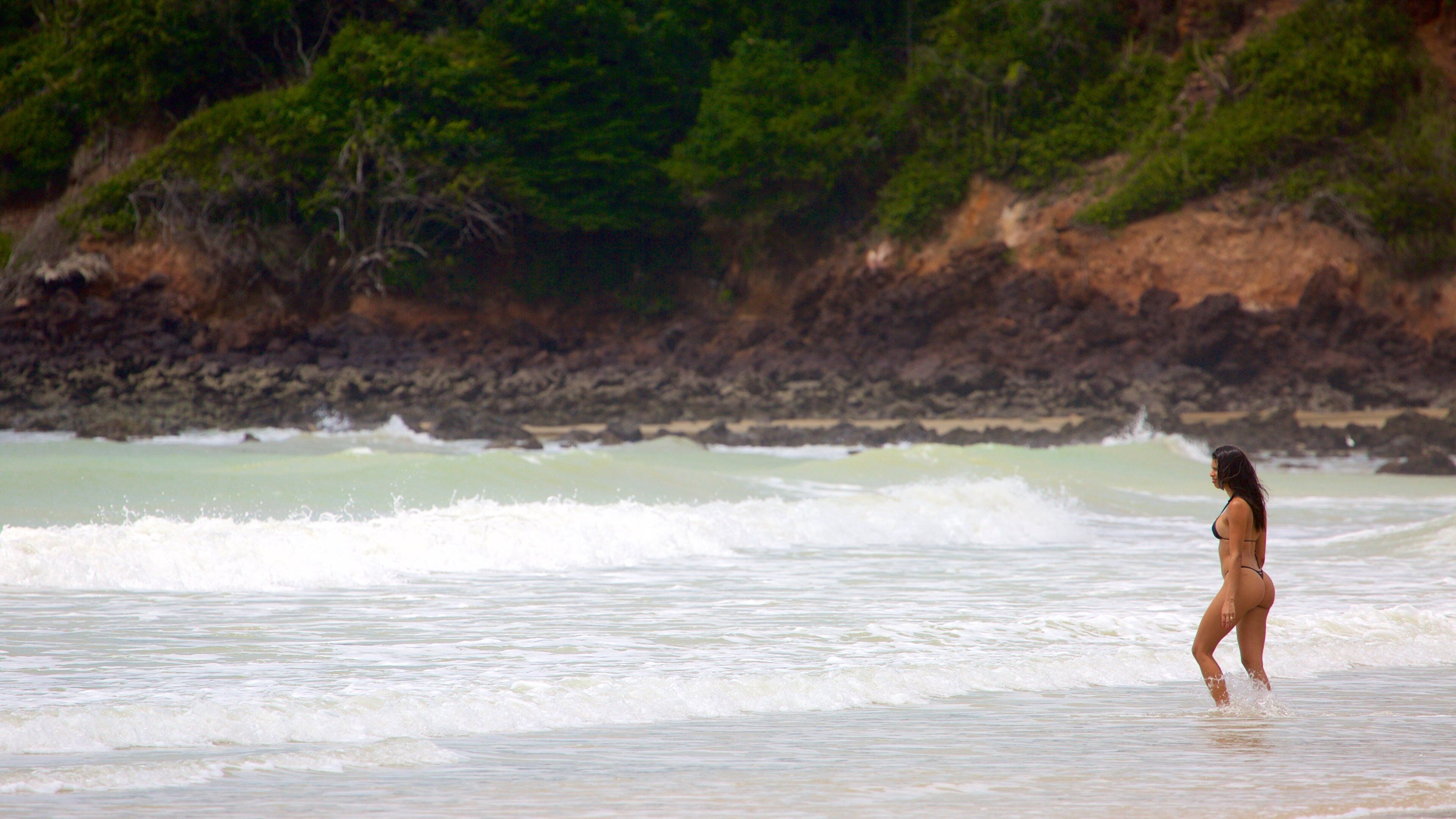 Playa de Cotovelo ofreciendo surf, litoral accidentado y vistas de una costa