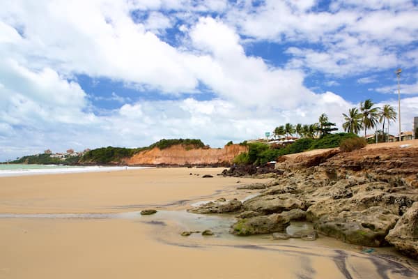 Cotovelo Beach which includes a sandy beach and general coastal views