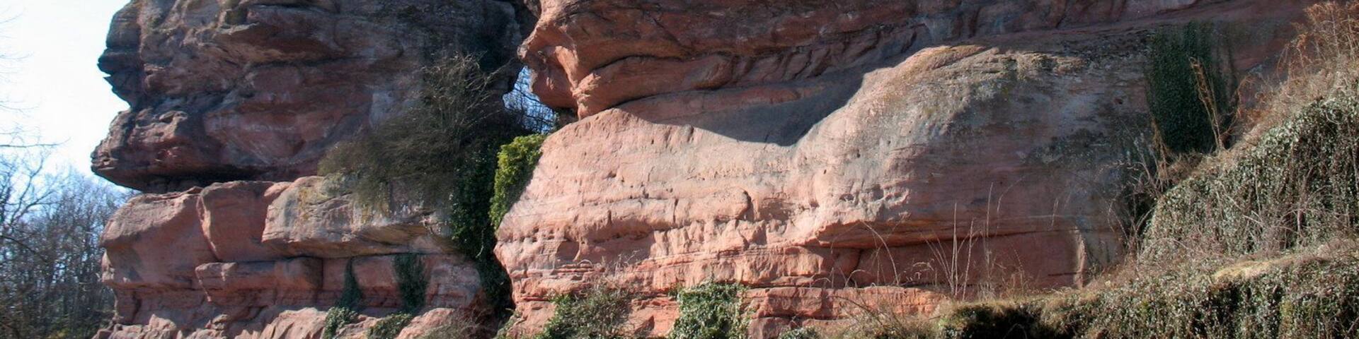 A rocky cliff with a metal bridge.