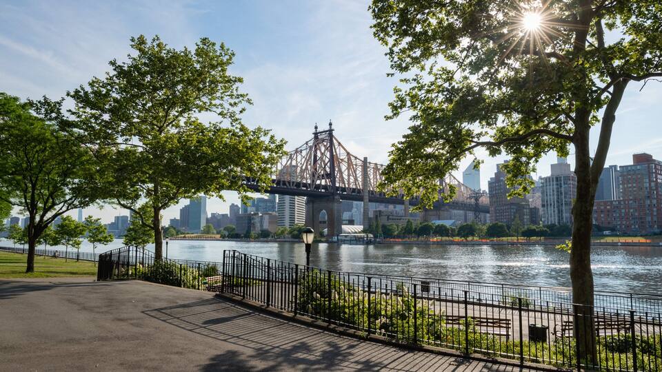 Queensbridge Park which includes a river or creek, a bridge and a sunset