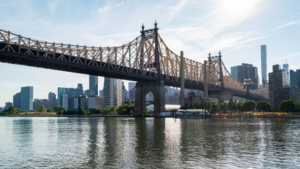 Queensbridge Park which includes a bridge, a city and a river or creek