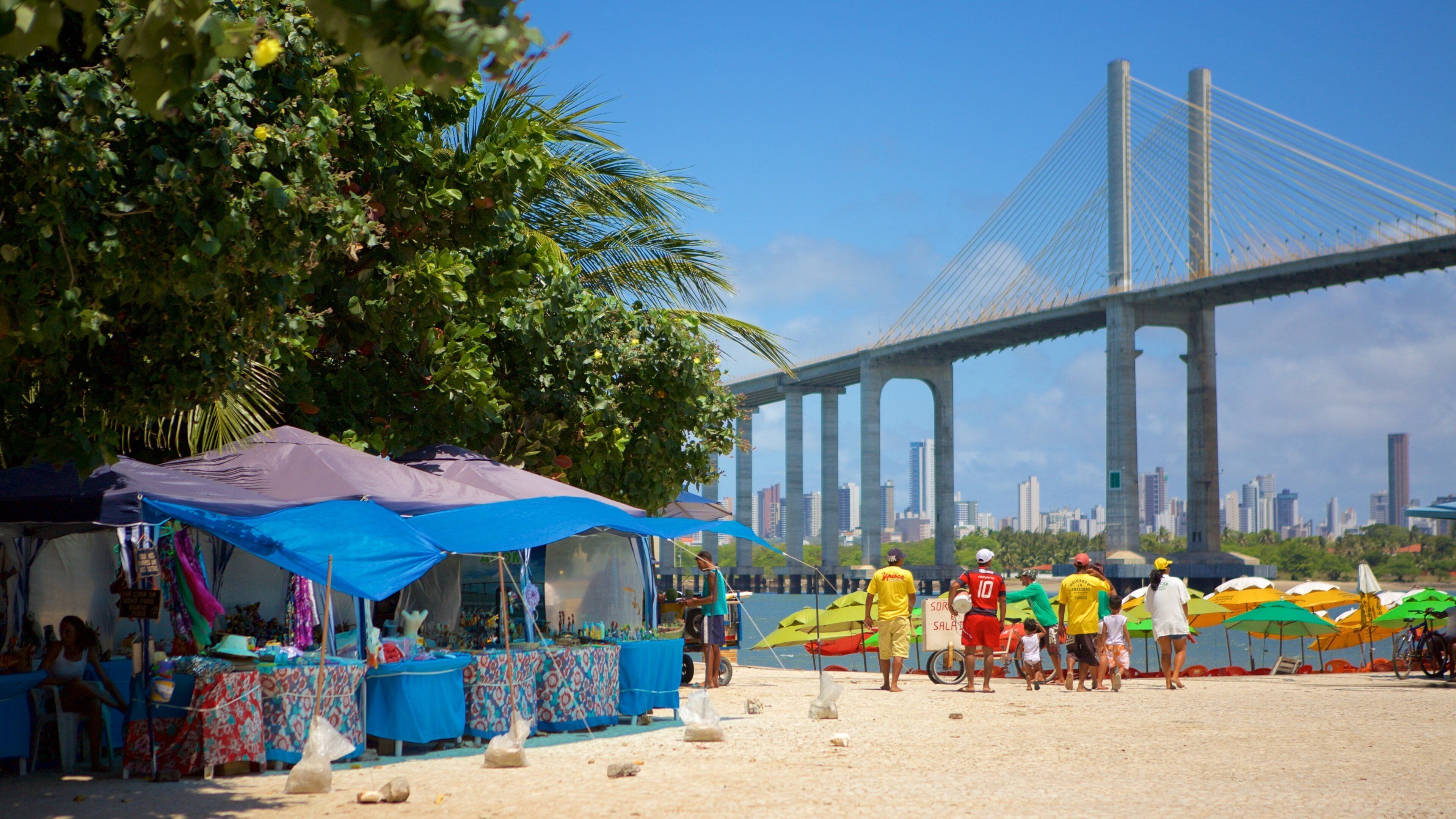 Redinha Beach which includes a bridge and markets as well as a small group of people