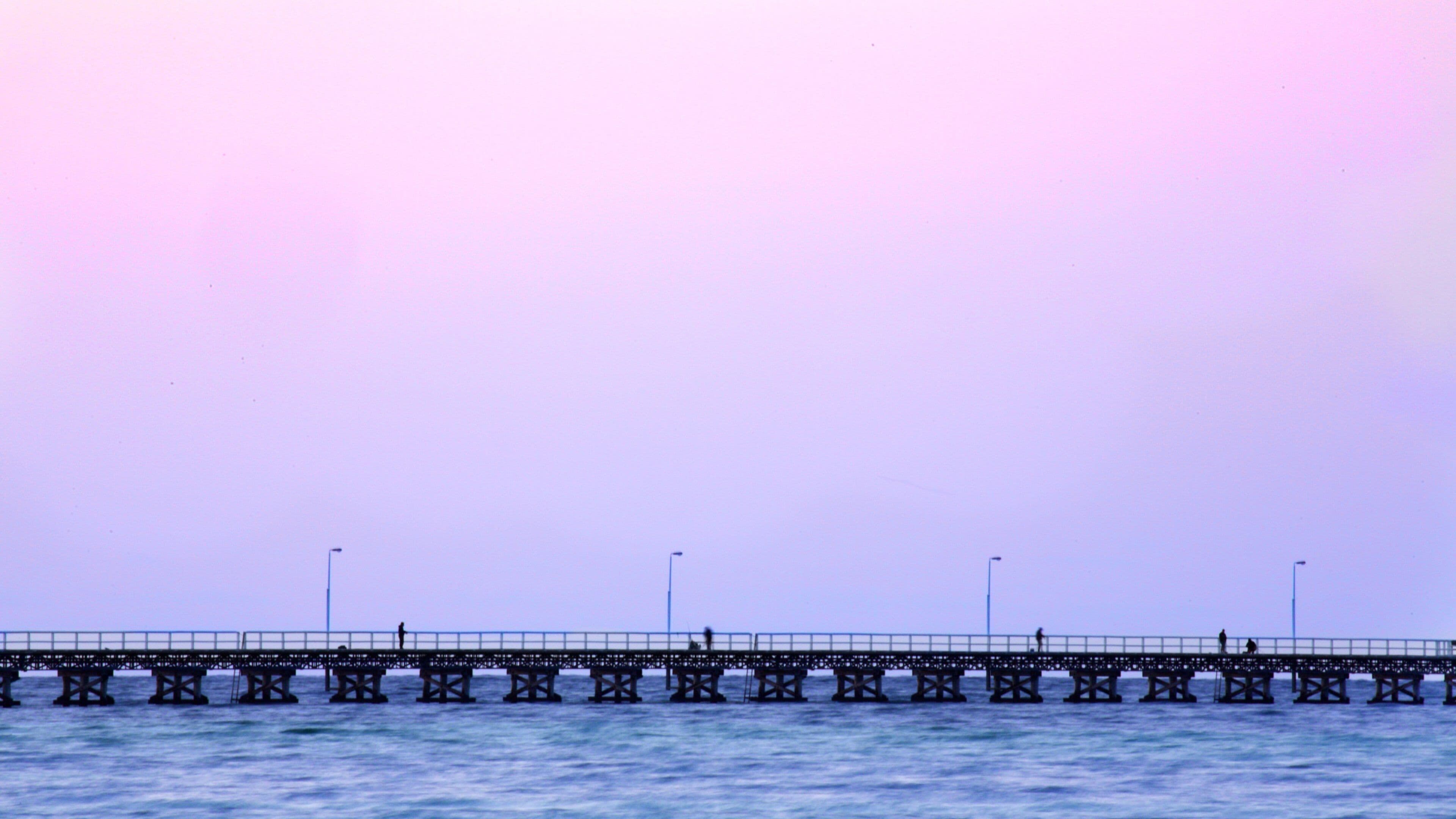Busselton Jetty which includes general coastal views and a sunset