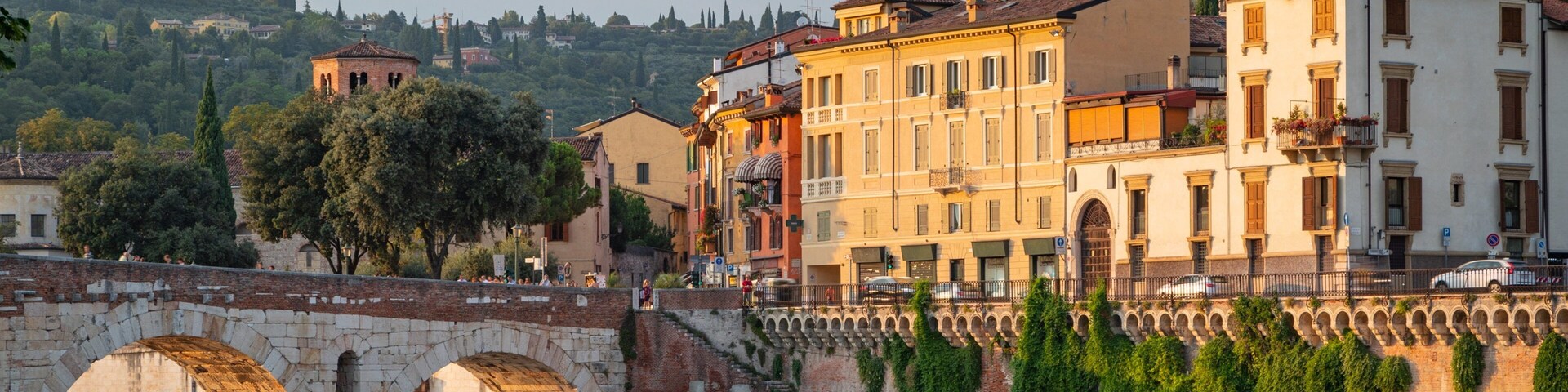 Adige River showing a bridge, a sunset and a river or creek