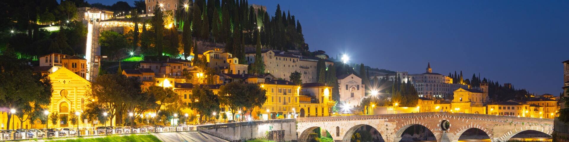 Adige River showing a river or creek, a bridge and night scenes
