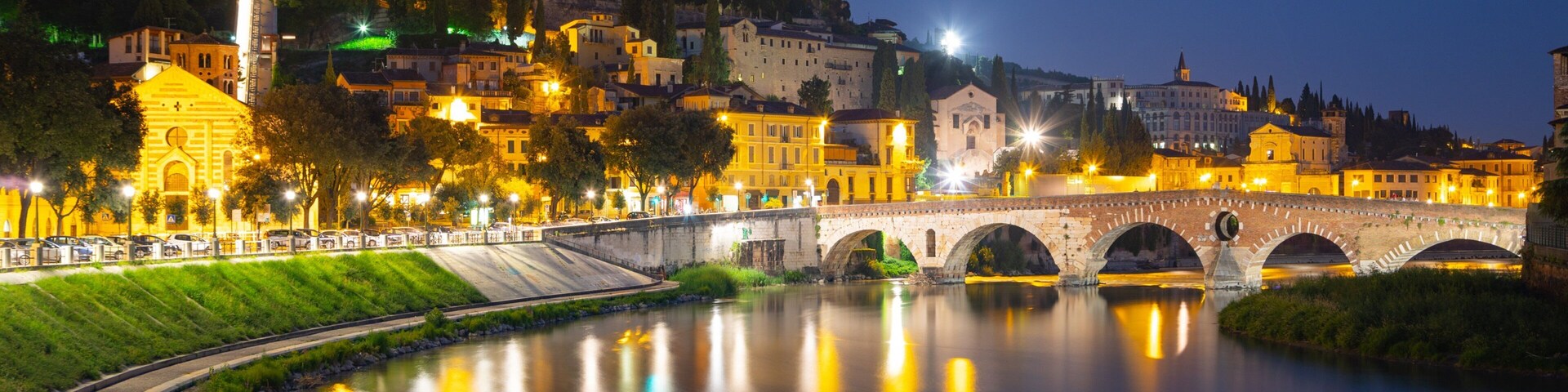 Adige River showing a river or creek, a bridge and night scenes