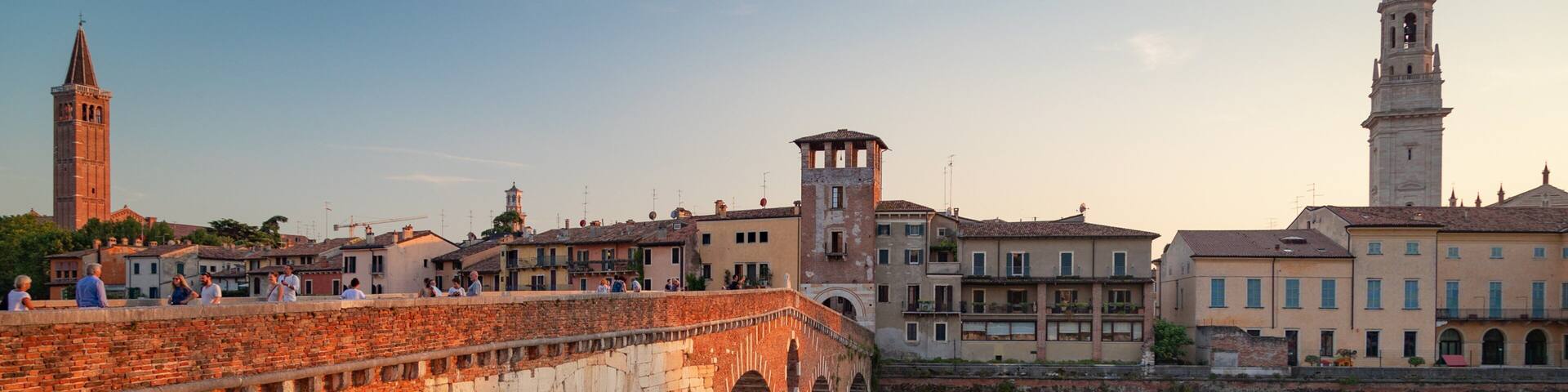 Adige River showing a river or creek, a sunset and a bridge