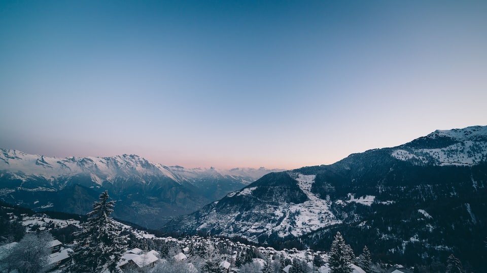 The swiss alps village of La Tzoumaz at dawn in winter, Valais, Switzerland.