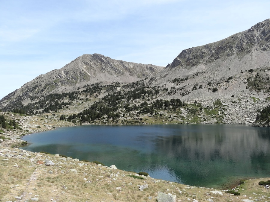 A mountain landscape with a clear lake and rocky terrain.