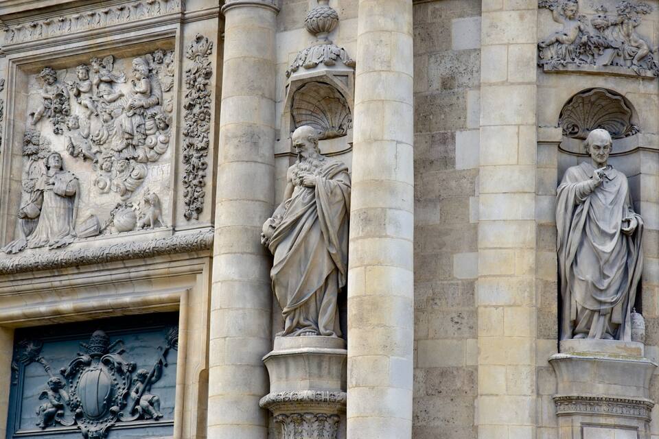 Detailed stone carvings and statues on a building facade.