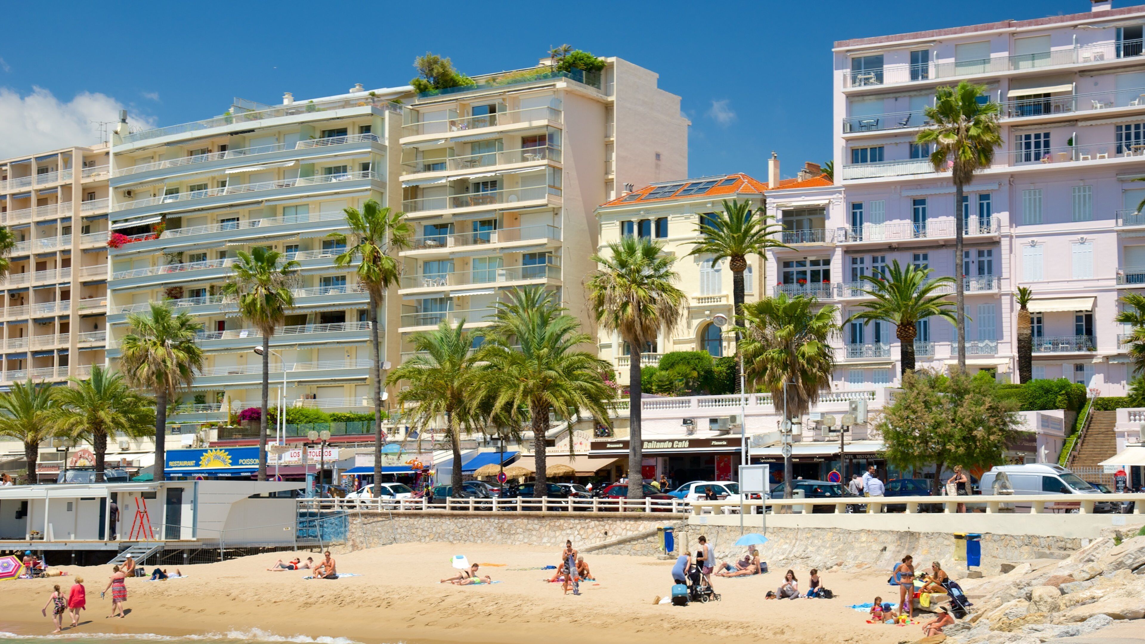 Midi Beach which includes a sandy beach and a coastal town
