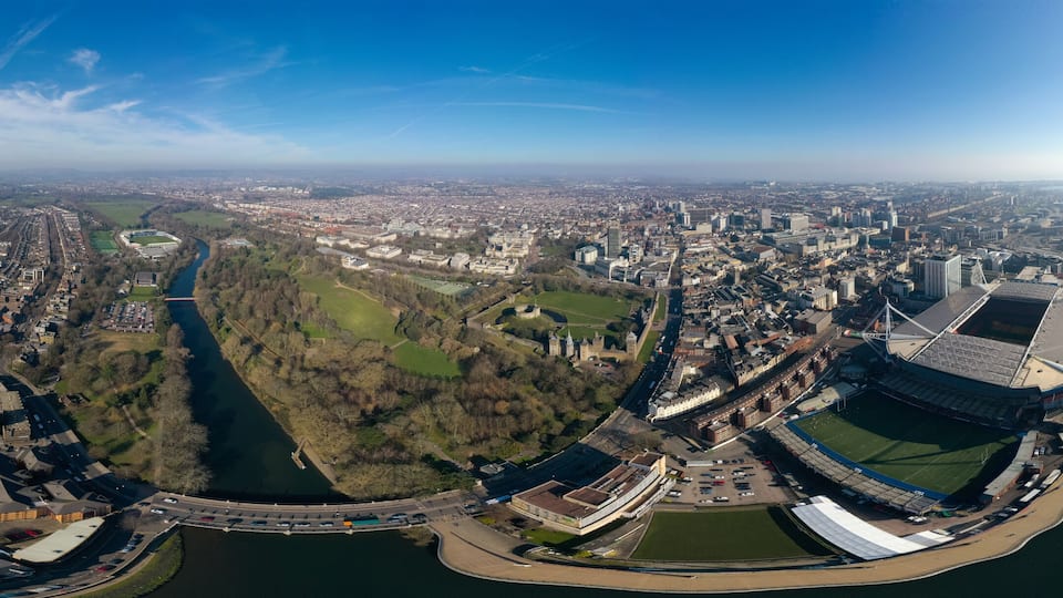 Cardiff aerial view panorama in Wales capital cityscape 360 panoramic skyline feat. River Taff, Principality Stadium, Cardiff Castle, famous landmarks and city center downtown streets from above in UK