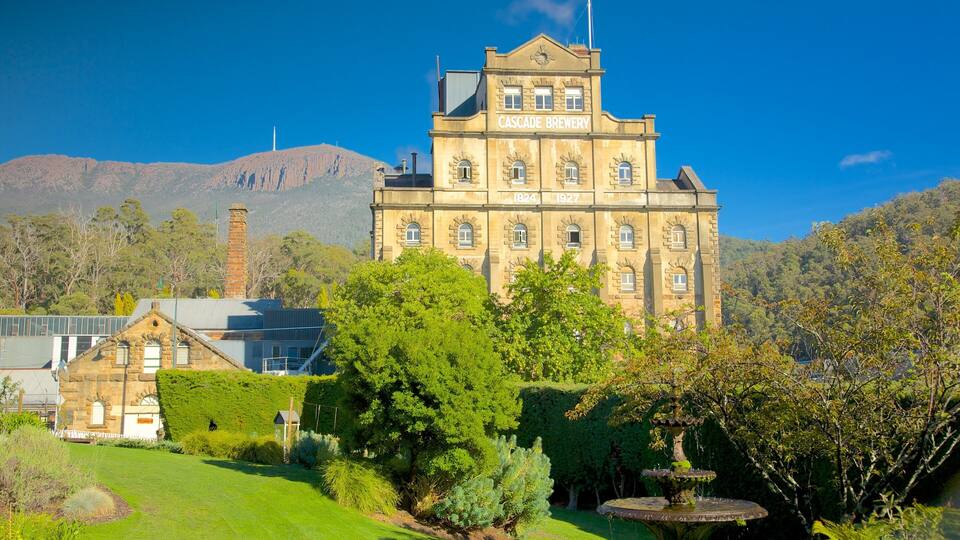 Cascade Brewery, a historic building surrounded by lush greenery and a mountainous backdrop.