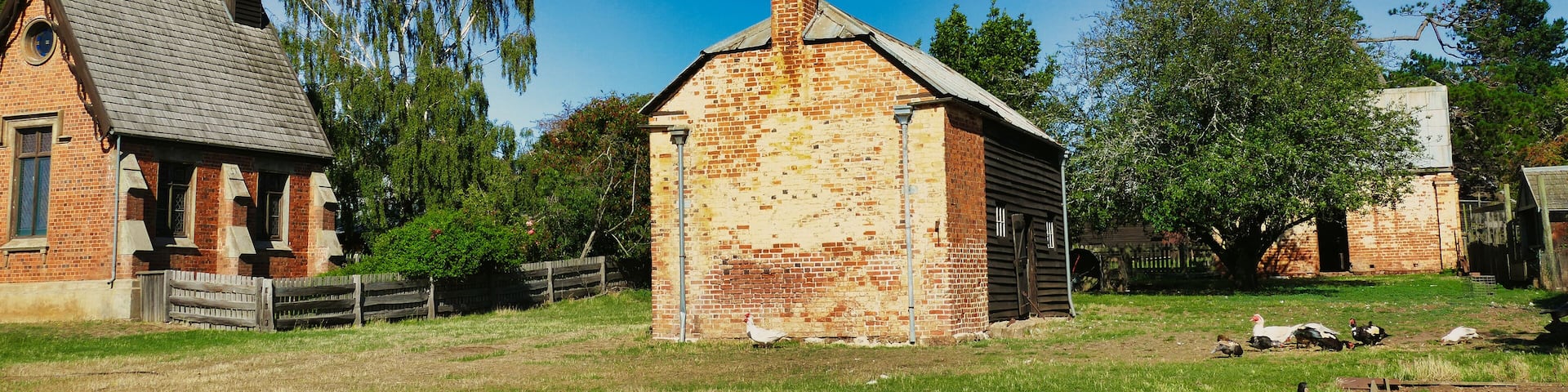 Tiny church, farm buildings and ducks in the historic farm and convict village Brickendon (1824), Longford, Tasmania, Australia, a world heritage site.
