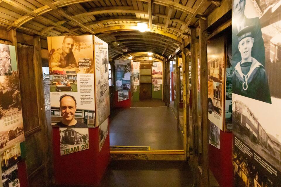 A train corridor with vintage posters and memorabilia.