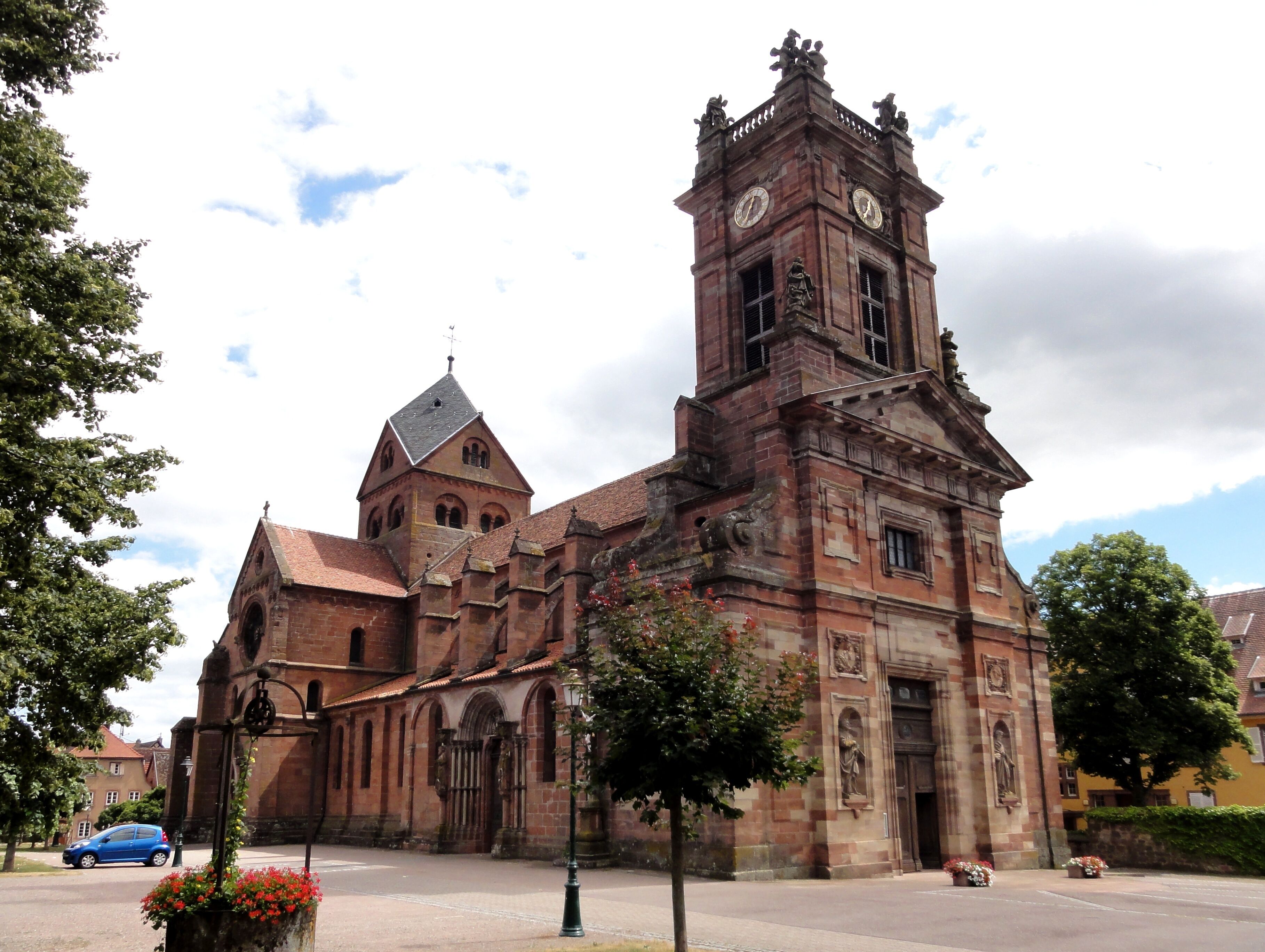 A historic church with a prominent tower, arched windows, and a clock.