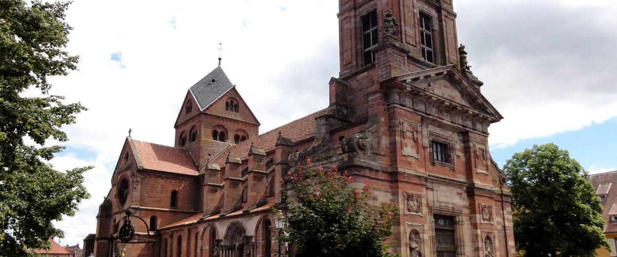 A historic church with a prominent tower, arched windows, and a clock.