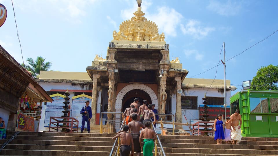 A temple entrance with ornate golden decorations and a large archway.