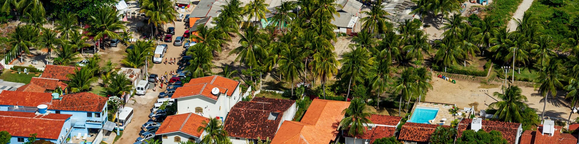Maria Farinha beach, Olinda, near Recife, Pernambuco State, Brazil on November 15, 2012. Aerial view of the beach with colorful parasols and countless people on the beach.