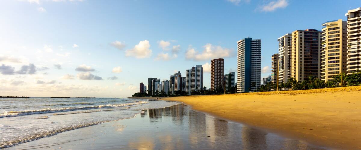 Apartment Buildings are mirroring at the Beach of Piedade early in the morning, just after sunrise. Jaboatao dos Guararapes, Pernambuco