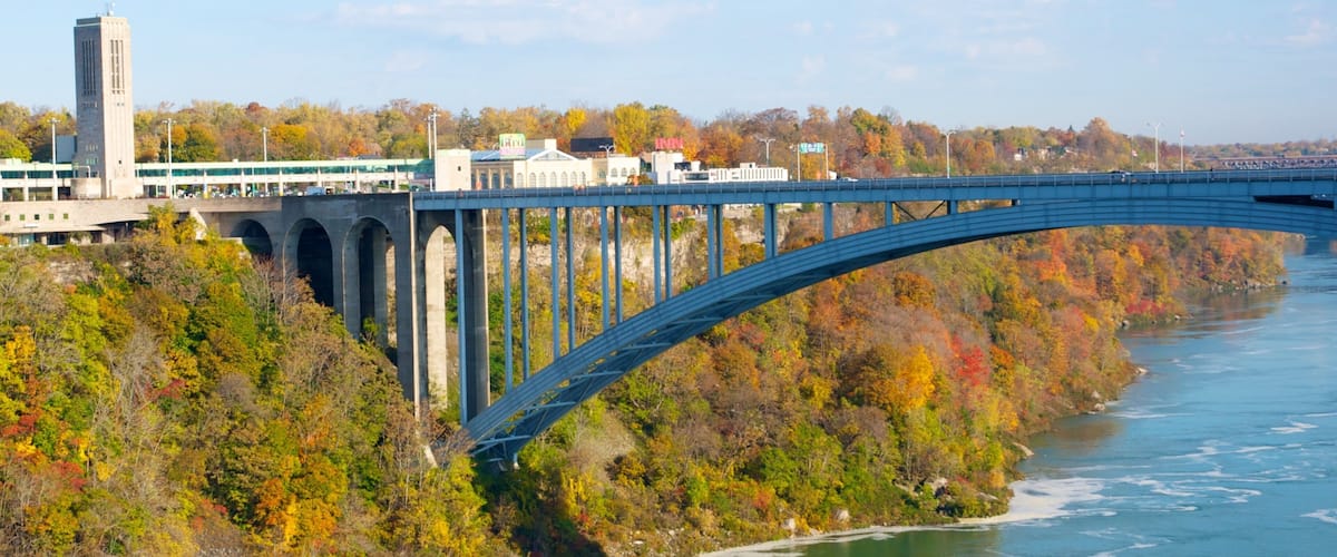 Rainbow Bridge showing autumn colours, a bridge and a river or creek