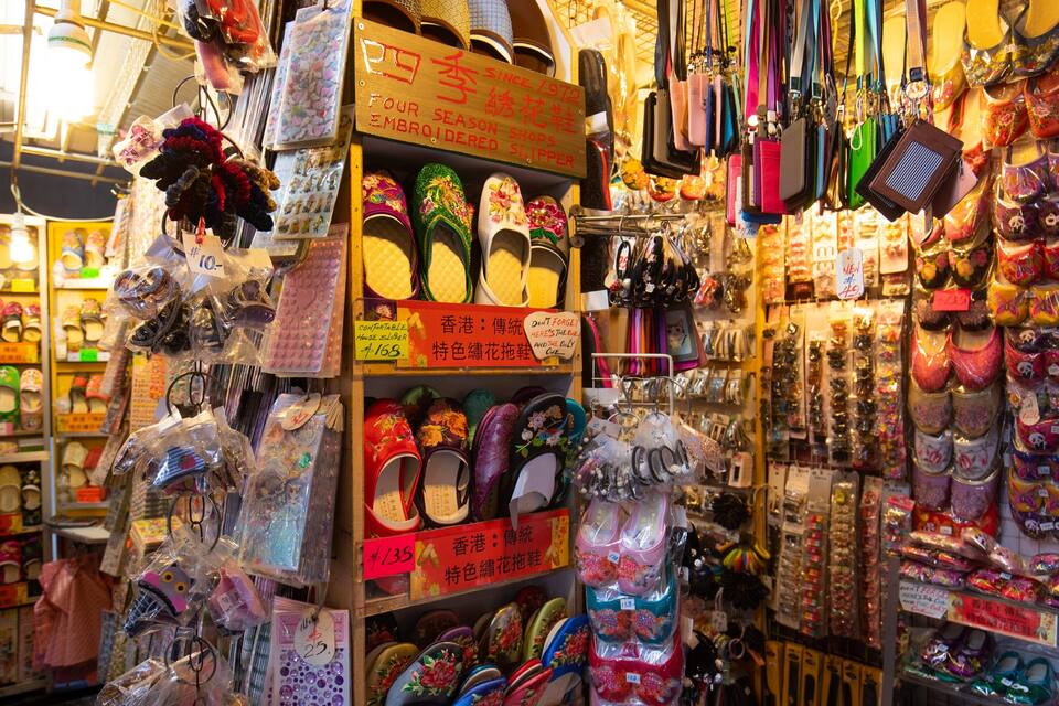 A variety of slippers and shoes on display in a shop.