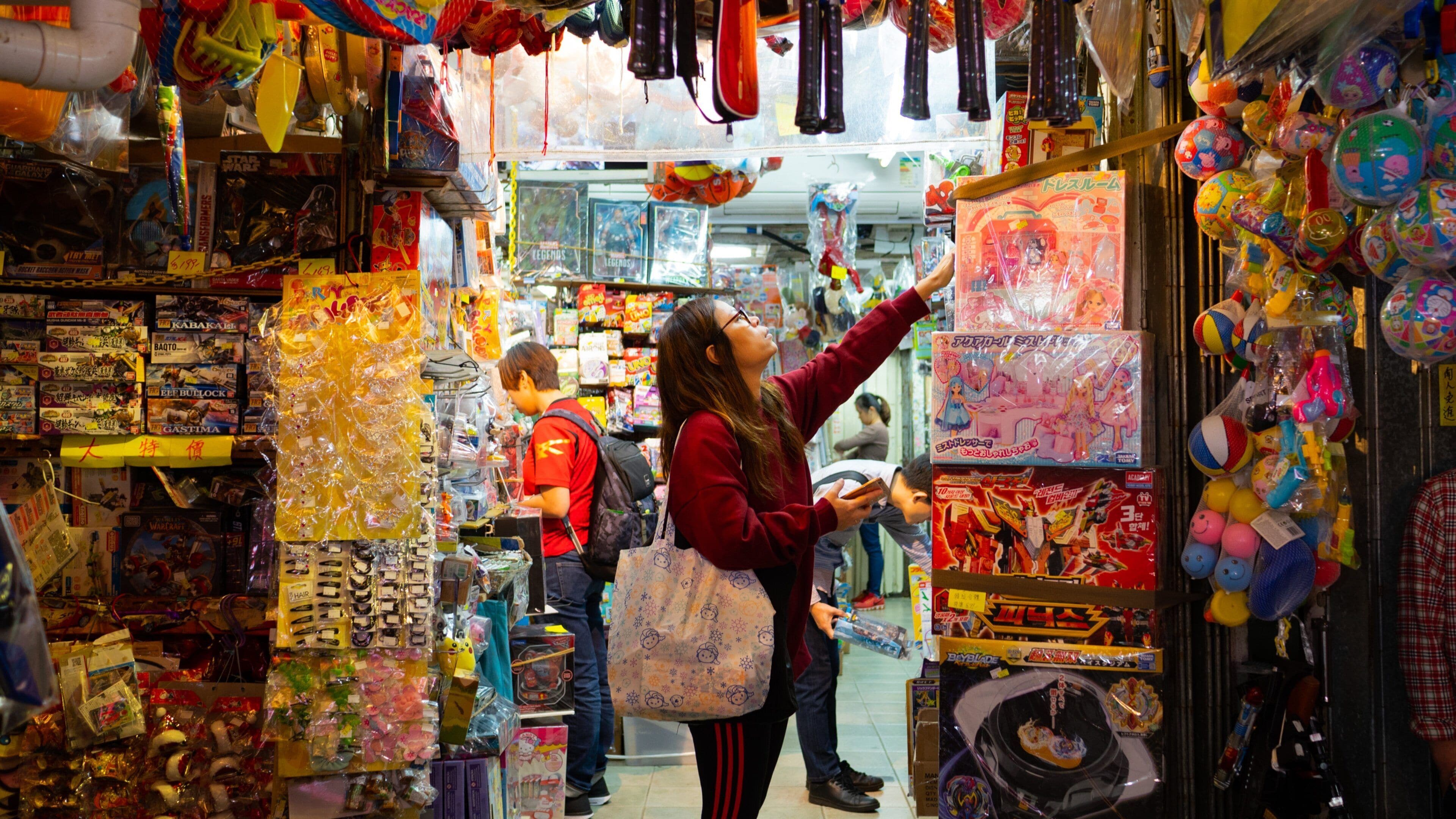 Tai Yuen Street Toy Market showing shopping and interior views as well as an individual femail