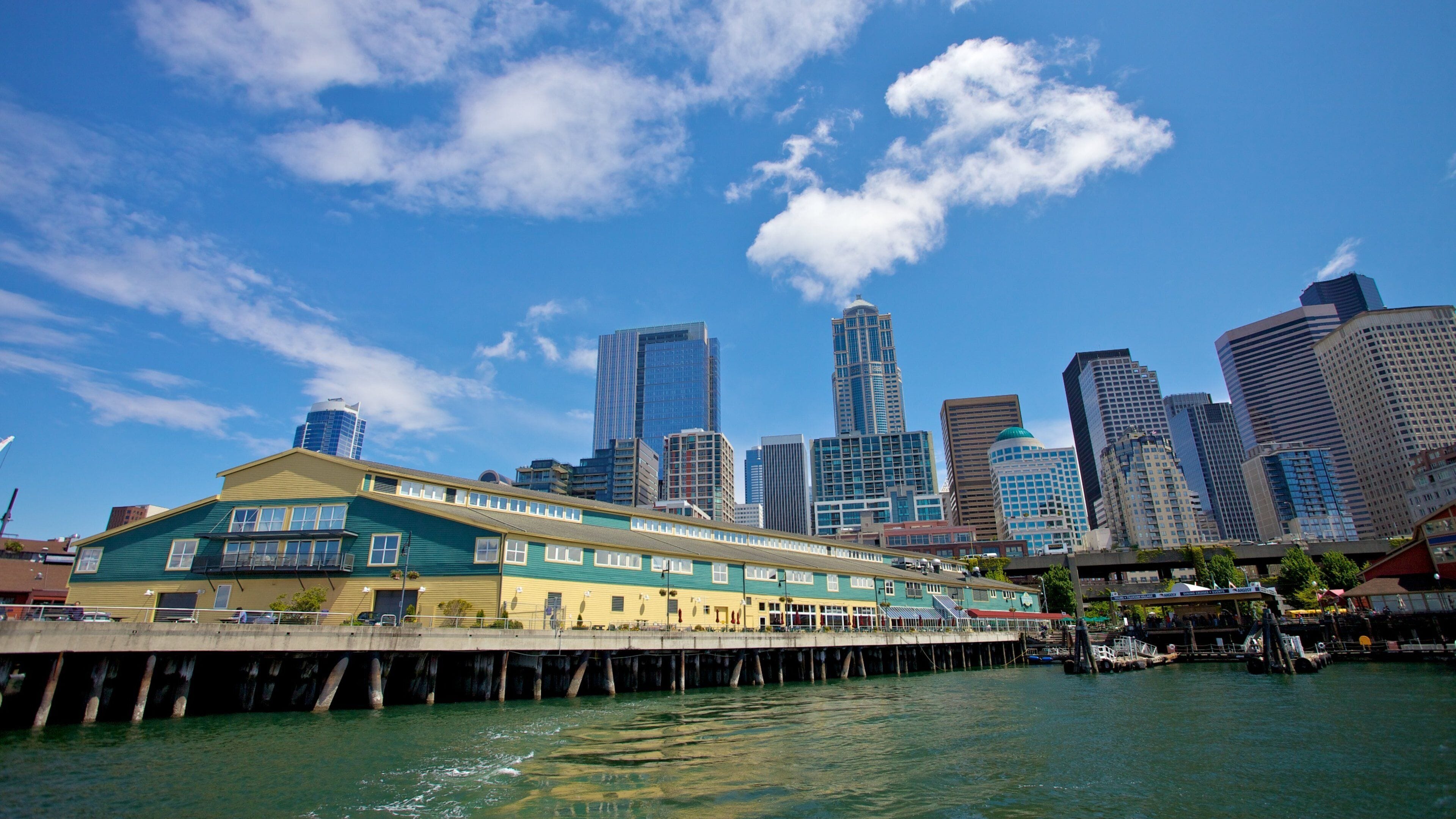 Seattle Waterfront showcases vibrant buildings and skyline under a bright blue sky