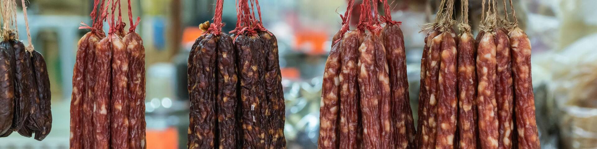 T864CK Hong Kong, China - March 8, 2019: Tai Po Market in New Territory. Closeup of Selection of dried sausages hangs in open window of store.