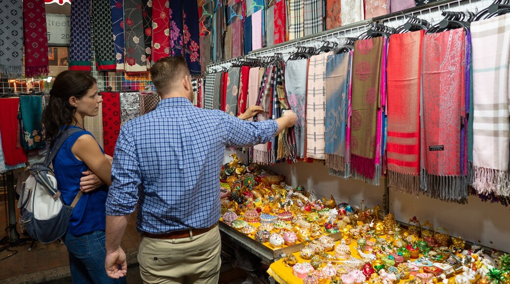 Temple Street Night Market showing shopping and markets as well as an individual male