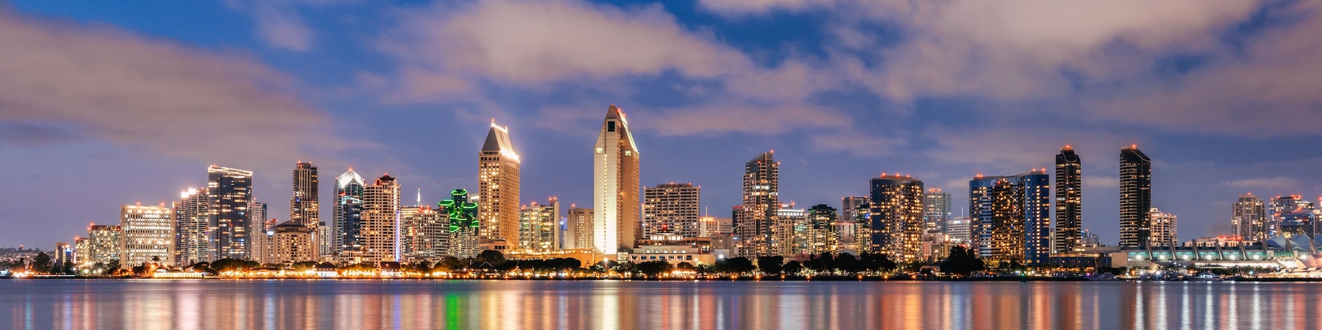 San Diego California skyline at night with reflections in water.