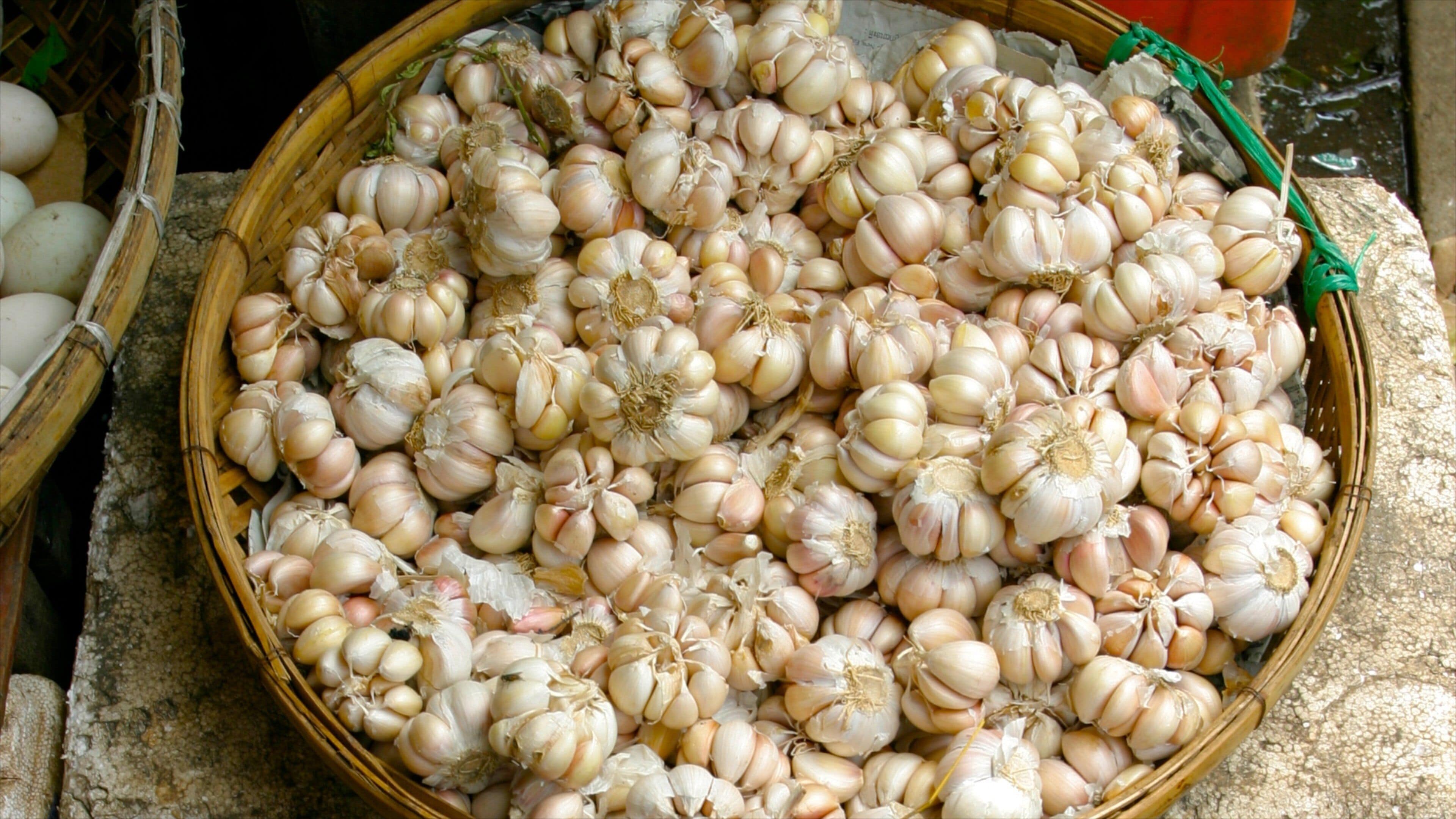 Market display of fresh garlic in Phnom Penh, Cambodia, showcasing vibrant local produce and culinary staples