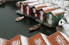 Boathouses with snowy roofs, Sweden.