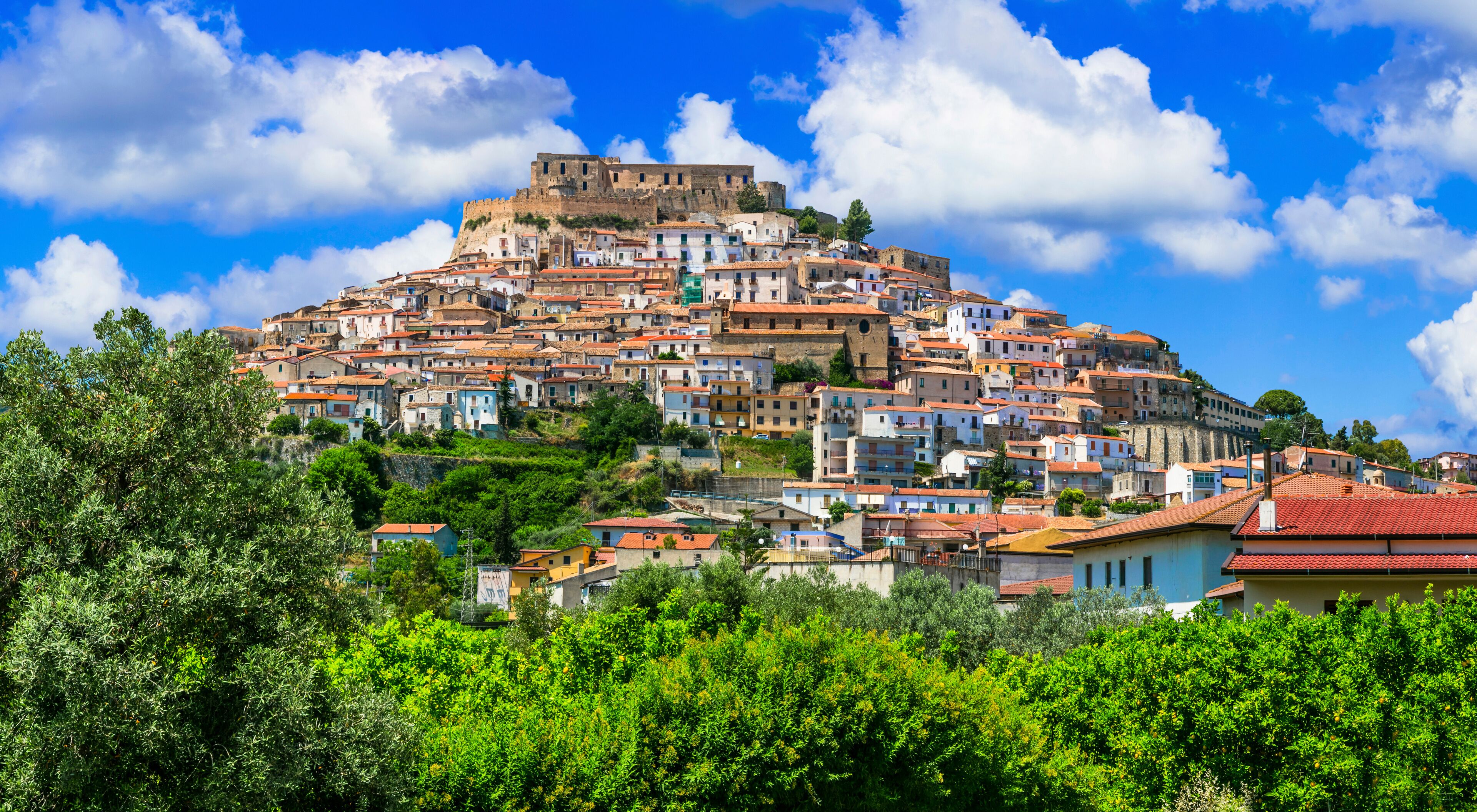 A hilltop town with historic buildings and a prominent fortress.