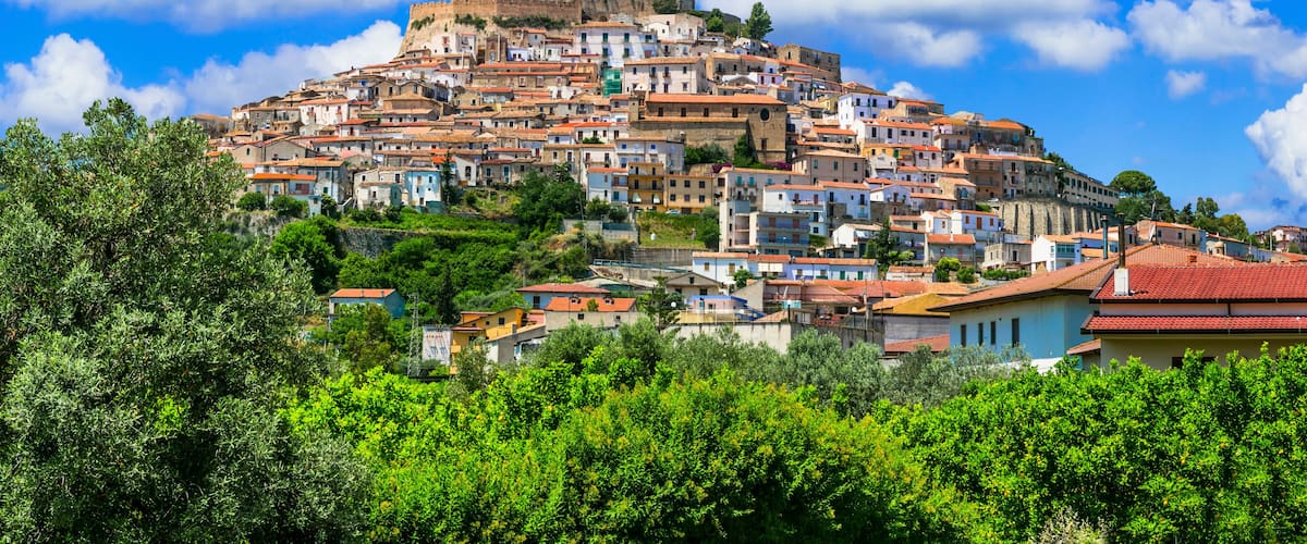 A hilltop town with historic buildings and a prominent fortress.