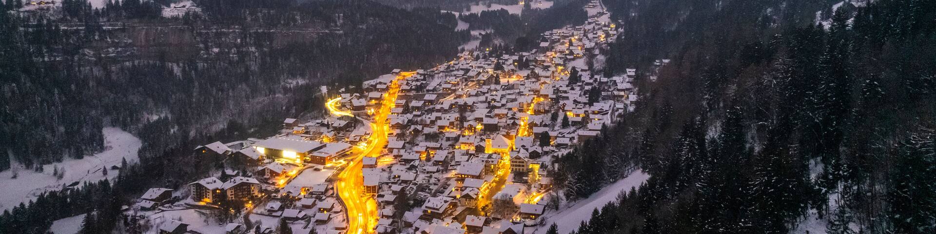 Aerial view of Champery at sunset, a small town on the Alps in wintertime with snow, Valais, Switzerland.