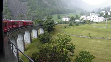 Bernina Express heading down the Brusio Circular Viaduct in Southern Switzerland.