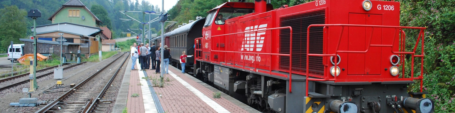 AVG Vossloh Class "G1206" 2,100 hp diesel hydraulic B-B No.561 at Langenbrand-Bermersbach train station on the Karlsruhe Hbf - Baiersbronn via Rastatt "Murgtalbahn" service, which was supposed to have been hauled by a Prussian "G12" 2-10-0. What a disappointment to have this hauling us! 09/12.