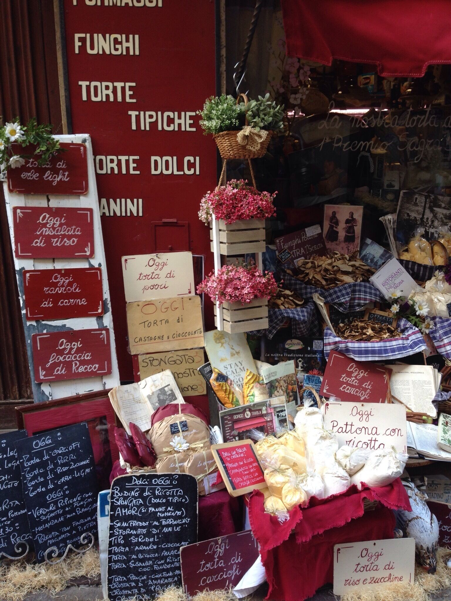 A market stall with various food items and signs indicating daily specials.