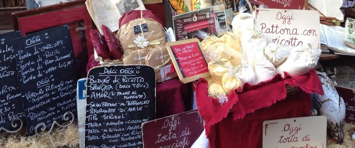 A market stall with various food items and signs indicating daily specials.