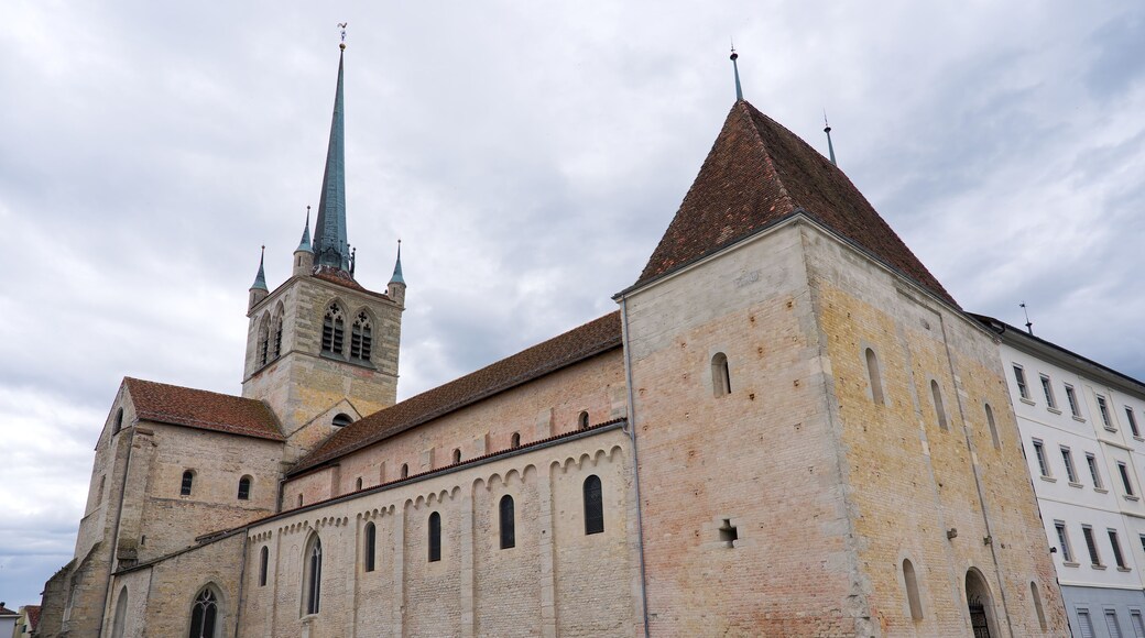 Looking up abbey church at Swiss city of Payerne on cloudy spring day. Photo taken June 6th, 2025, Payerne, Switzerland.