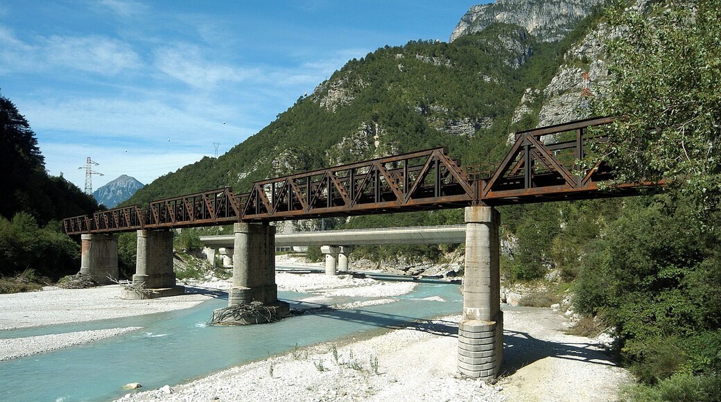 Railroad bridge across the river Fella, part of a defunct railroad line called the old "Pontebbana", in the north-eastern part of Italy, region Friuli Venezia-Giulia. In the background there are the two bridges of the Autostrada Alpe-Adria.