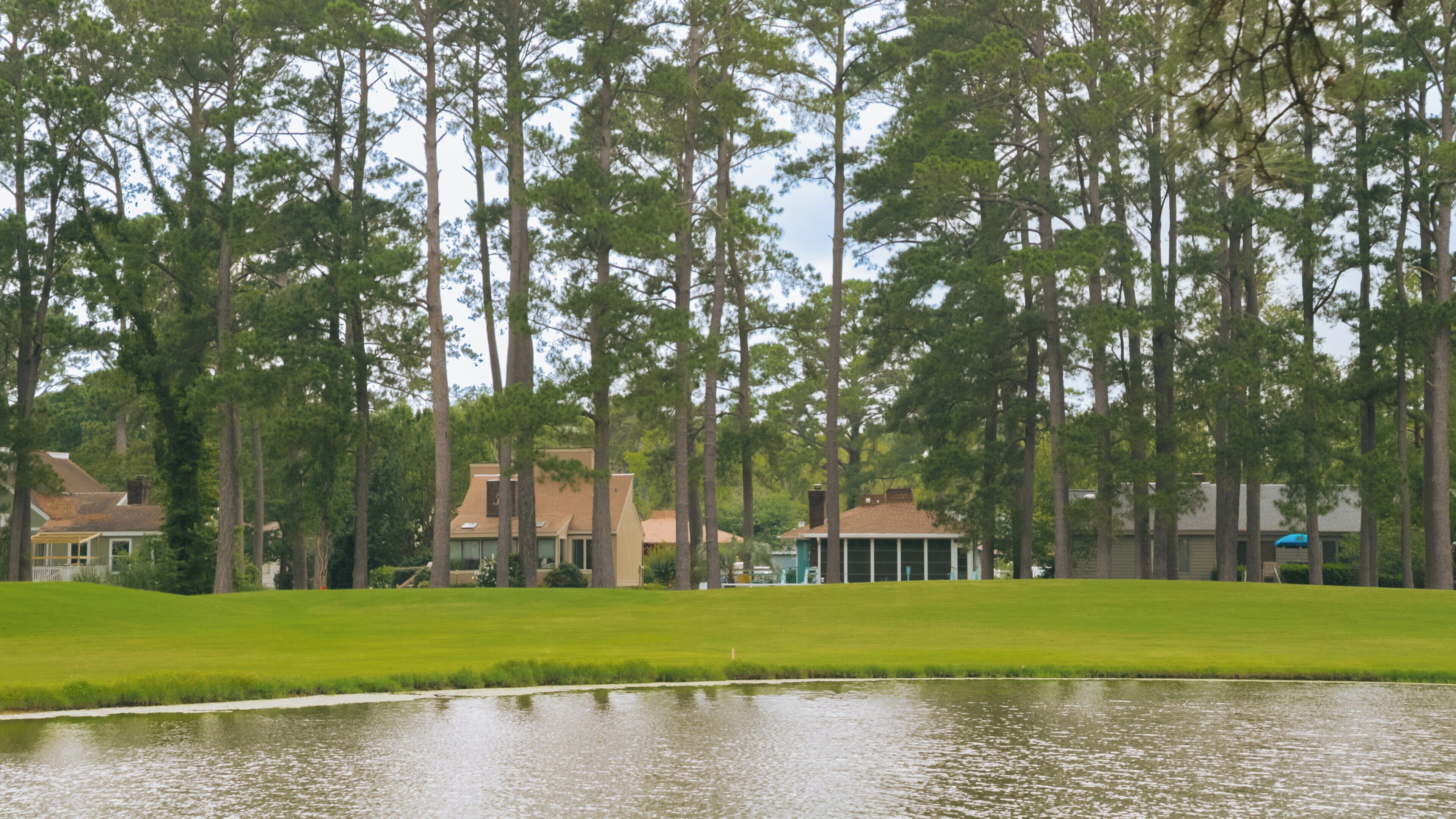 Myrtlewood Golf Club offers a serene landscape with rolling greens and tall trees in the heart of Central Myrtle Beach, South Carolina, ideal for golf enthusiasts and nature lovers