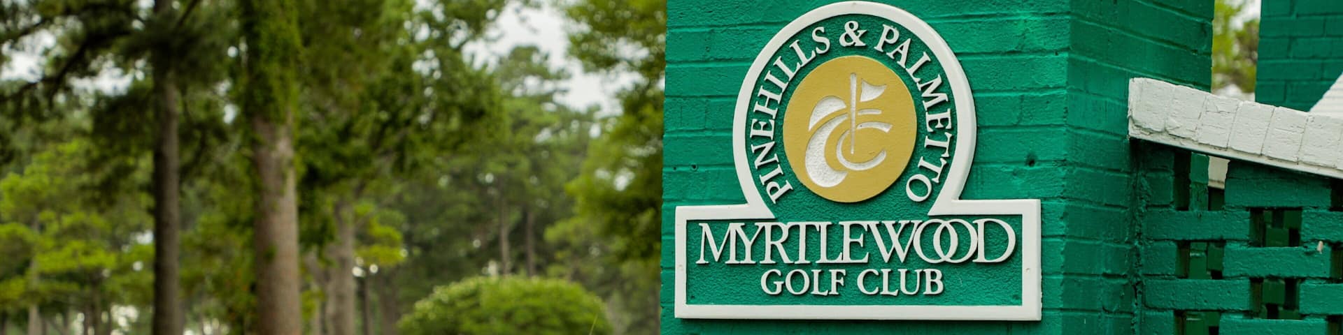 A green sign with the text "Pinnacles & Palmetto Golf Club" and "Myrtlewood Golf Club".