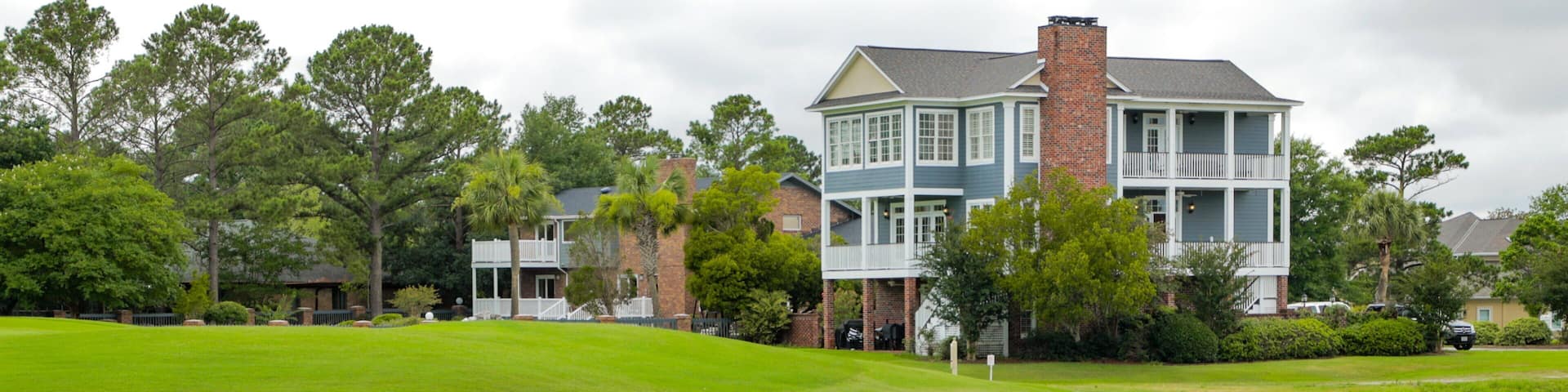Myrtlewood Golf Club featuring a bridge, a river or creek and a house